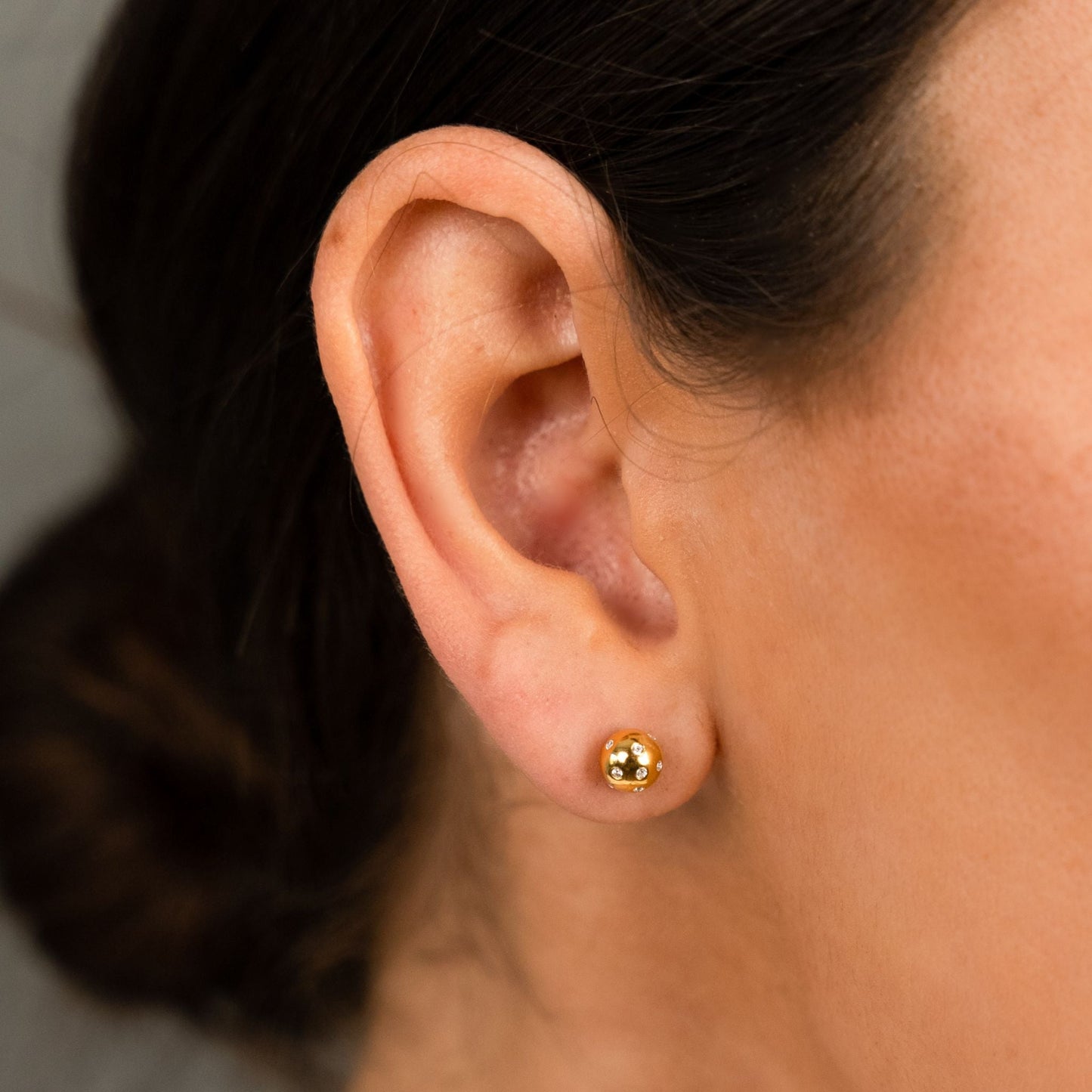 female model wearing the fran ball stud earring in 18k gold vermeil