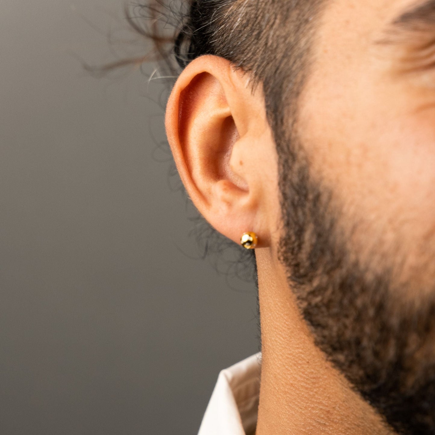 male model wearing the fran ball stud earring in 18k gold vermeil