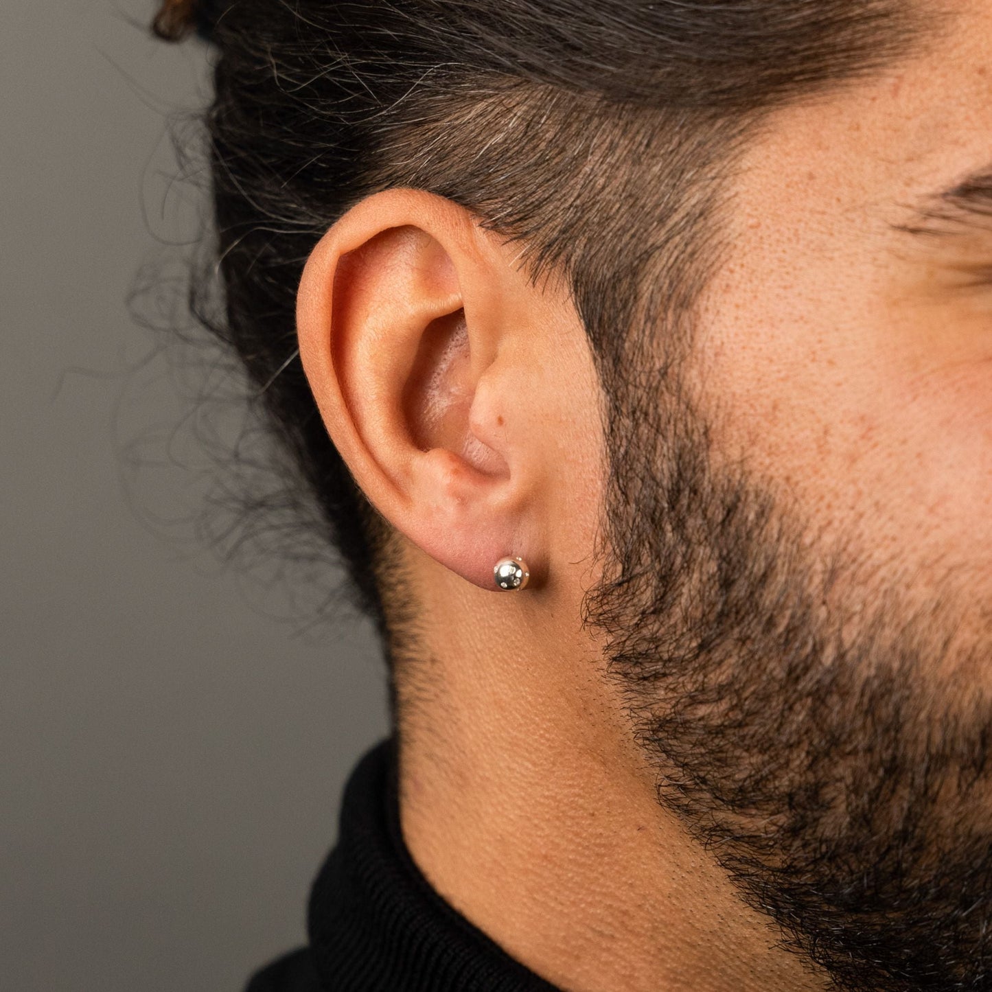 male model wearing the fran ball stud earring in sterling silver