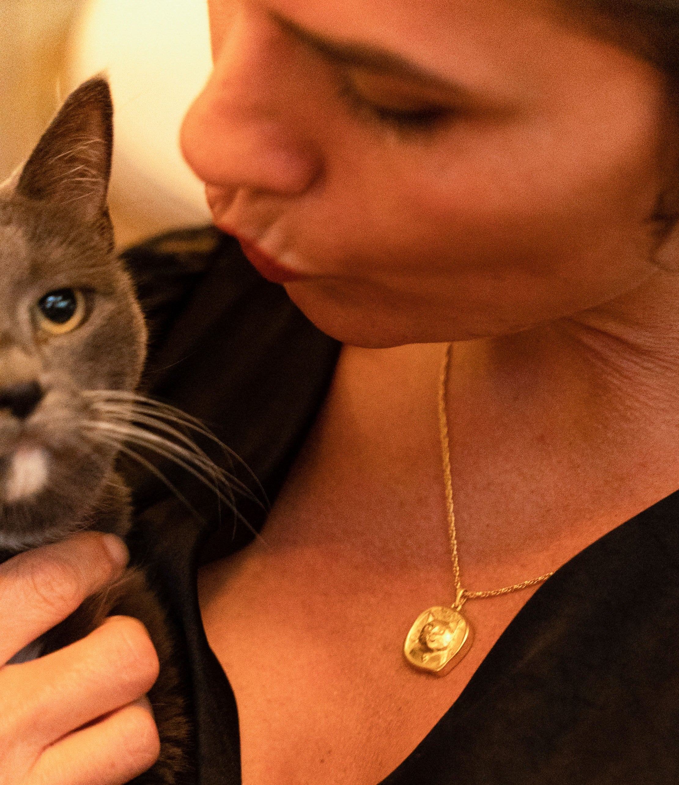 female model wearing FRENVYRN jewelry while holding cat