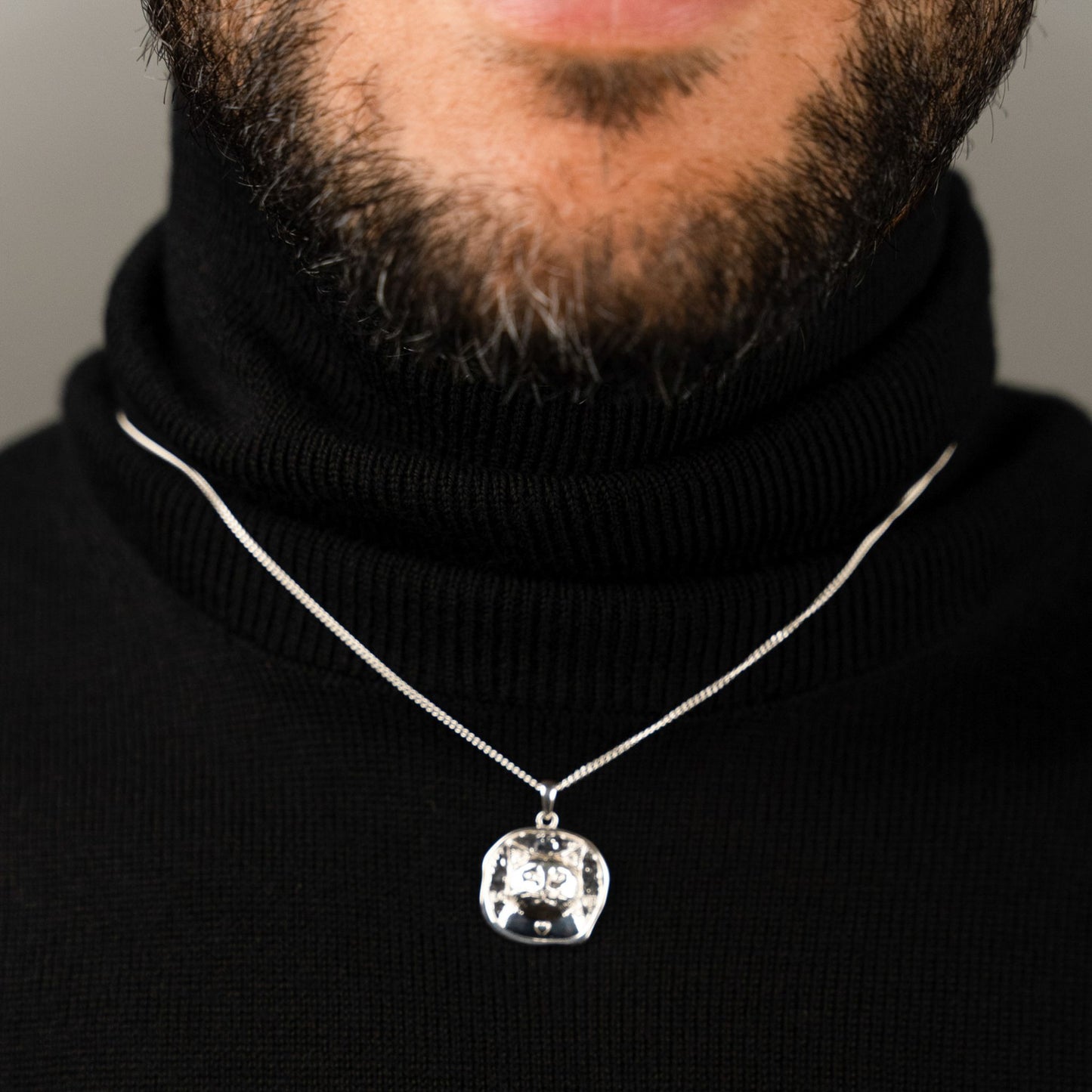 male model wearing the lars cat coin necklace in sterling silver