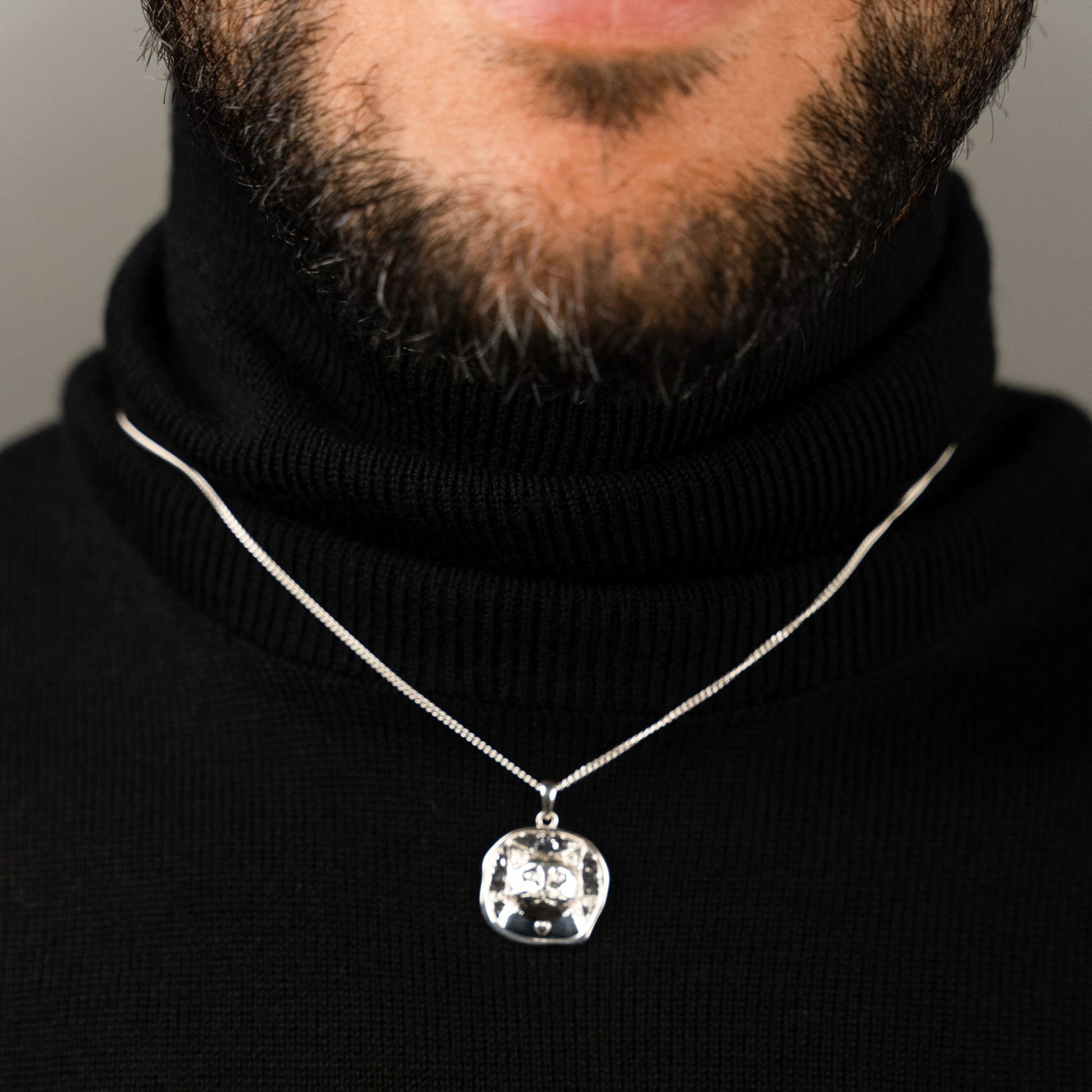 male model wearing the lars cat coin necklace in sterling silver