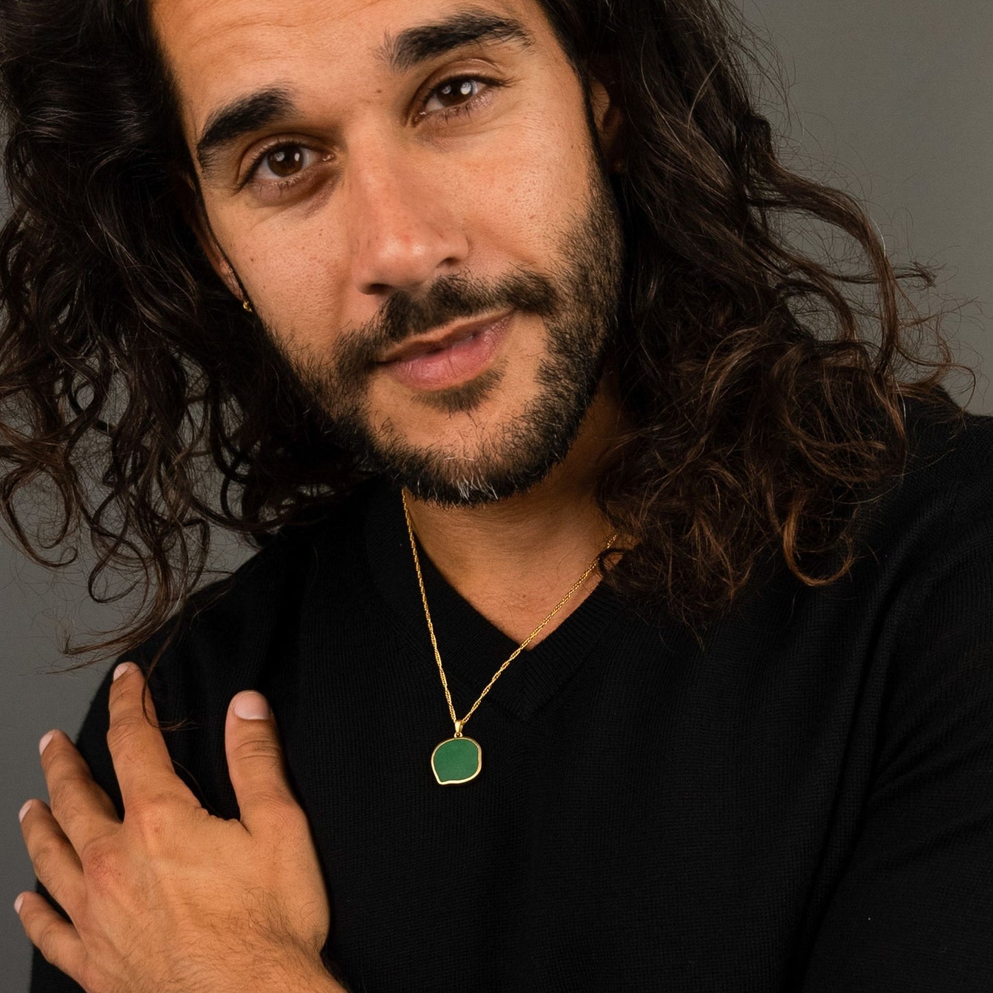 male model wearing the lars reversible cat coin necklace in 18k gold vermeil reversed, green aventurine