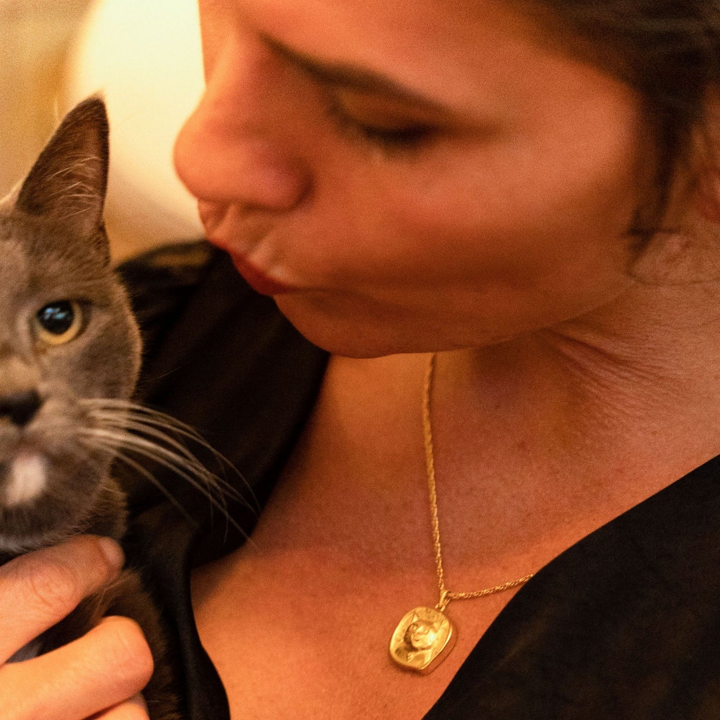 female model wearing the lars reversible cat coin necklace in 18k gold vermeil