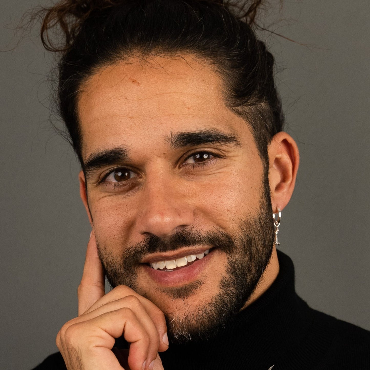 male model wearing the mars dog bone huggie hoop earring in sterling silver