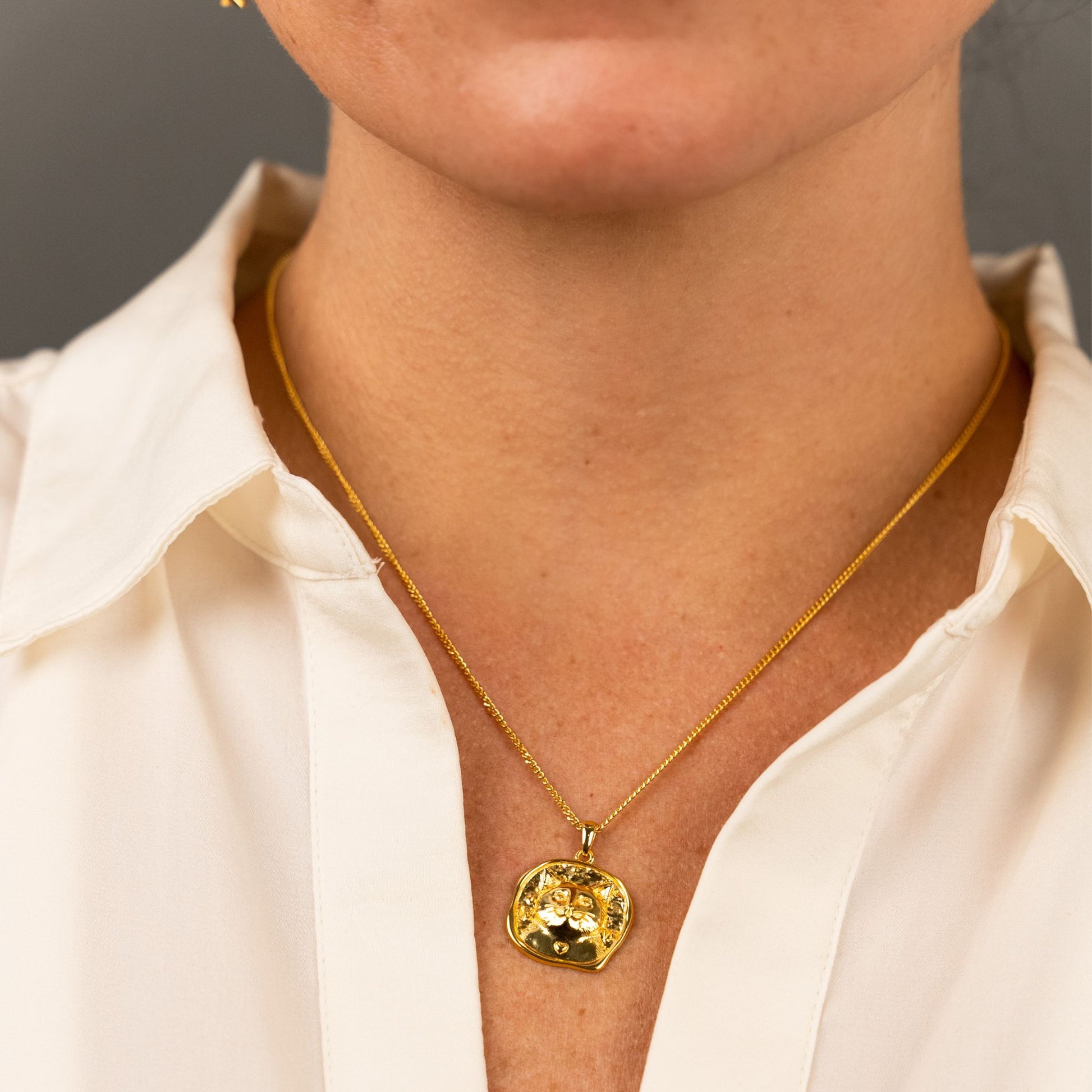 female model wearing the lars cat coin necklace in 18k gold vermeil