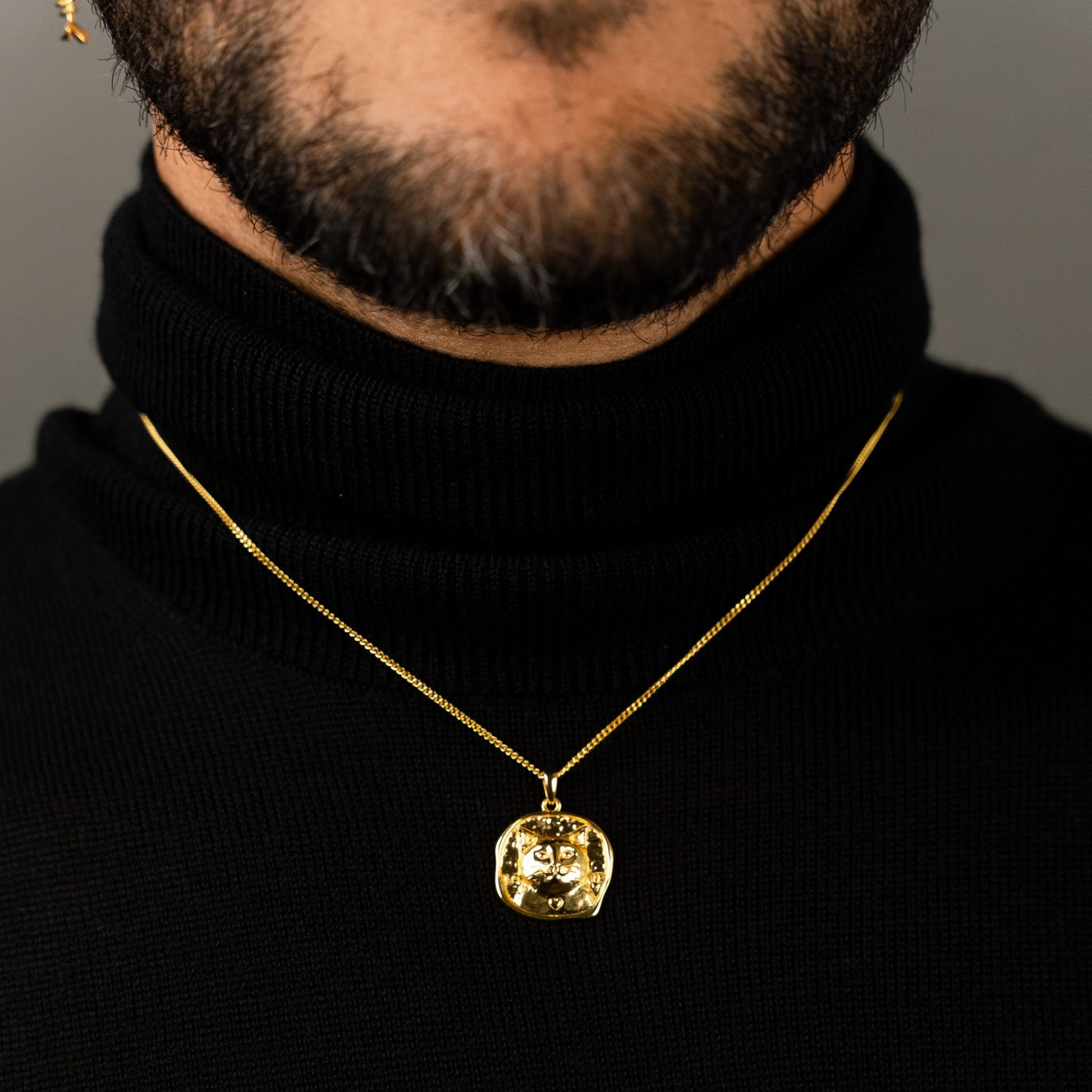 male model wearing the lars cat coin necklace in 18k gold vermeil
