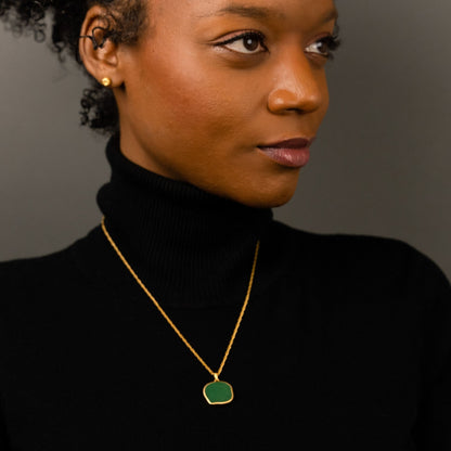 female model wearing the lars reversible cat coin necklace in 18k gold vermeil reversed, green aventurine