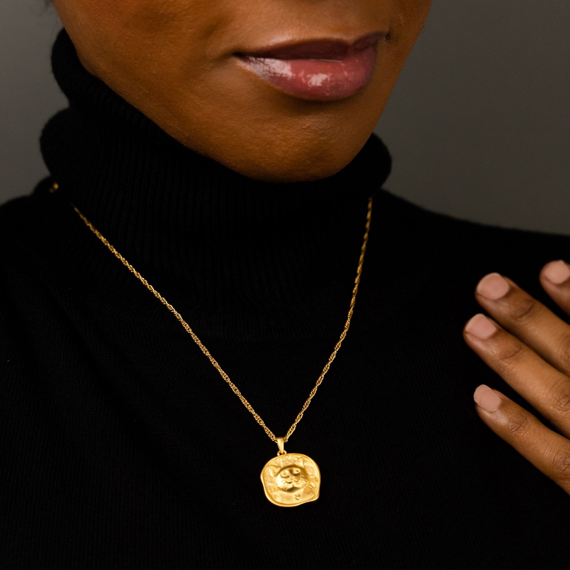 female model wearing the lars reversible cat coin necklace in 18k gold vermeil