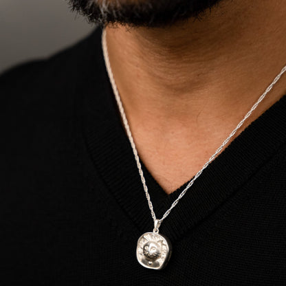 male model wearing the lars reversible cat coin necklace in sterling silver