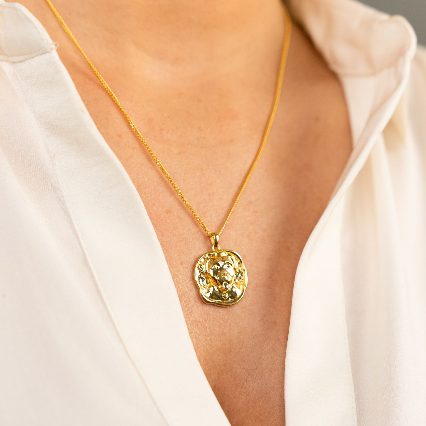 female model wearing the lars dog coin necklace in 18k gold vermeil