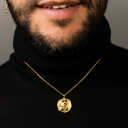 male model wearing the lars dog coin necklace in 18k gold vermeil and the mars dog bone huggie hoop earring in 18k gold vermeil