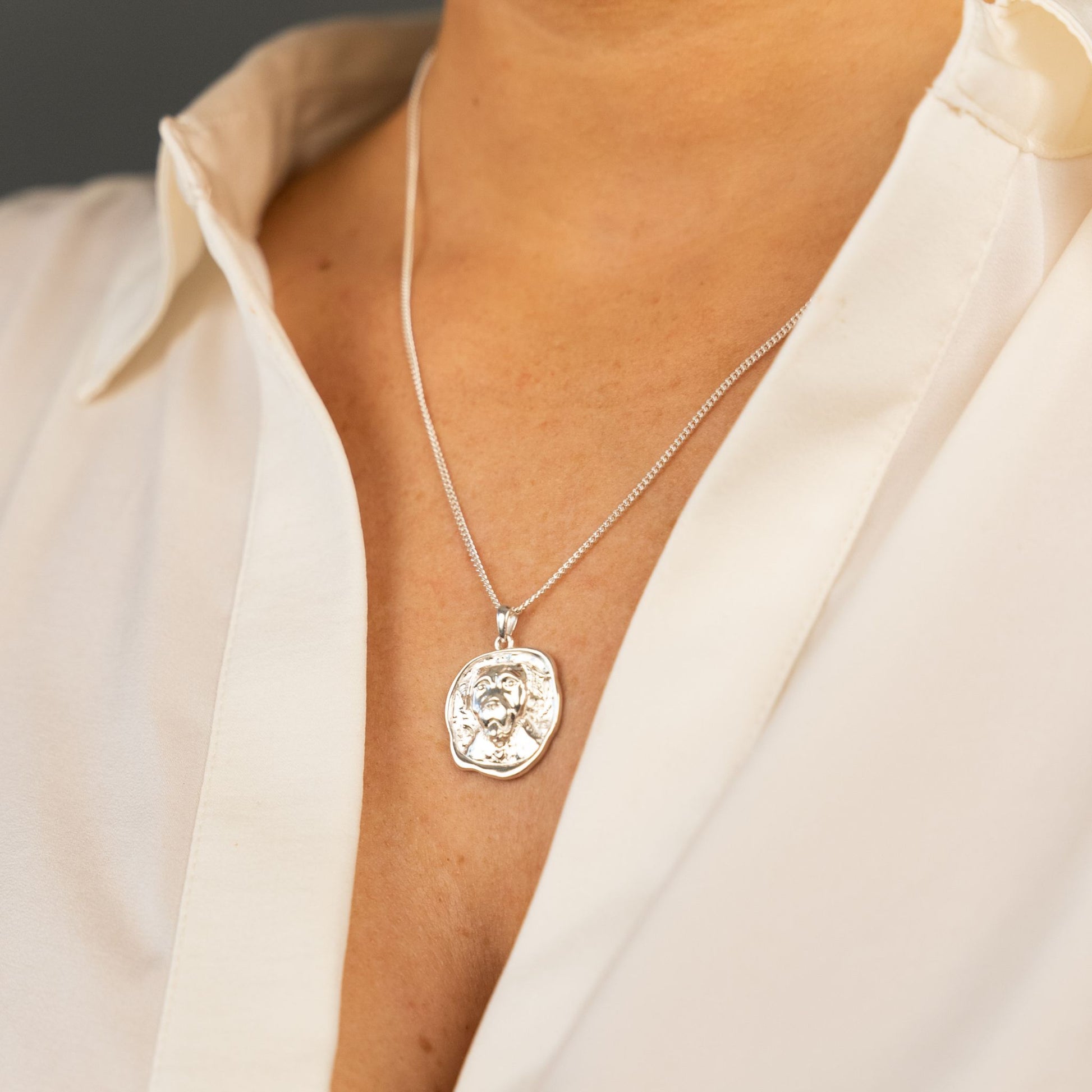 female model wearing the lars dog coin necklace in sterling silver