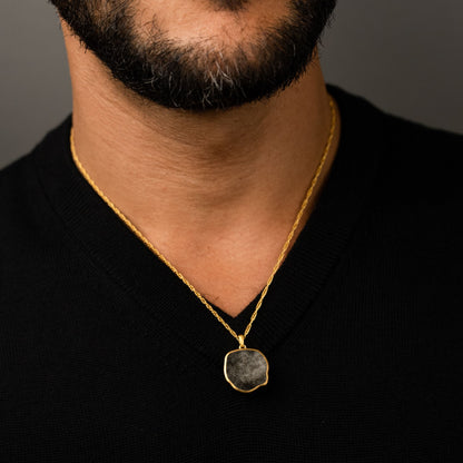 male model wearing the lars reversible dog coin necklace in 18k gold vermeil reversed, silver sheen obsidian