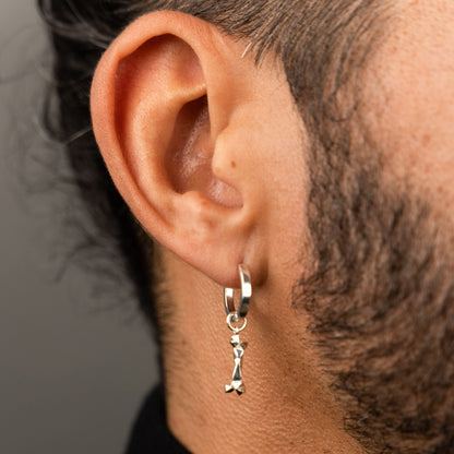 male model wearing the mars dog bone huggie hoop earring in sterling silver