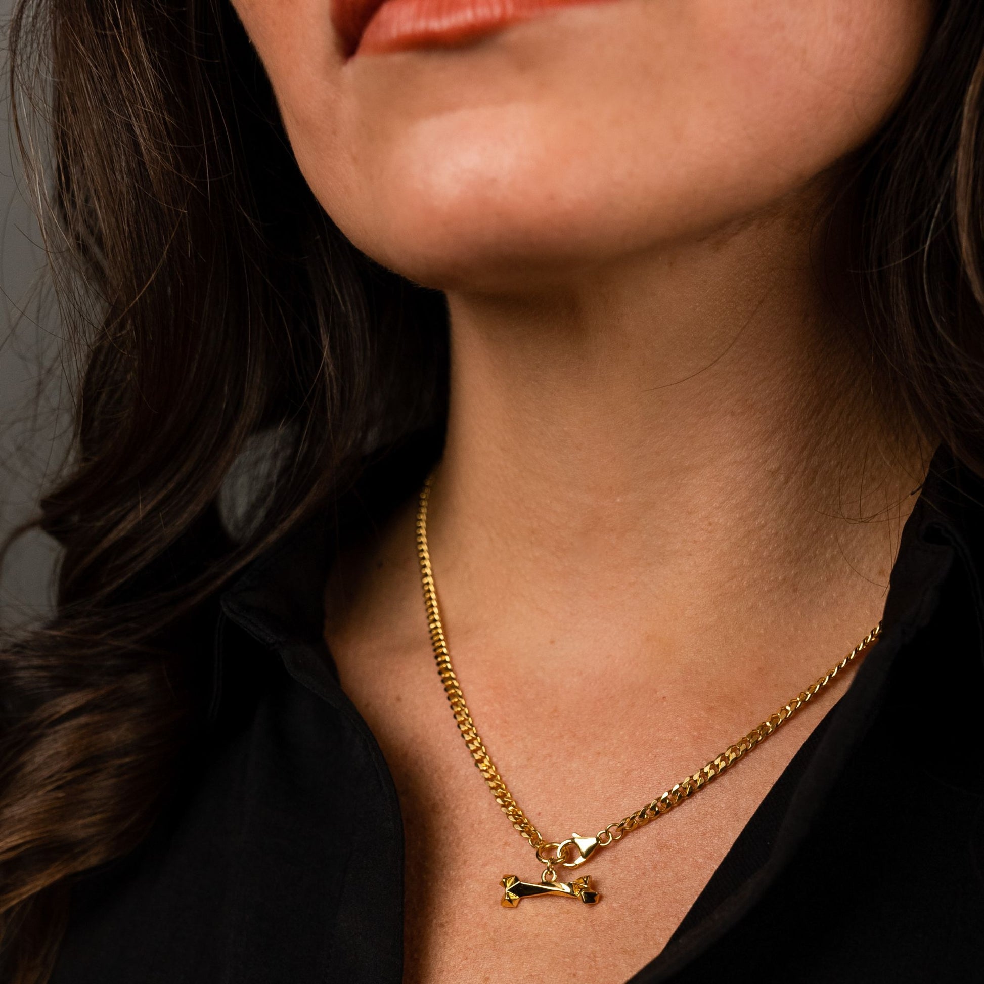 female model wearing the mars dog bone necklace in 18k gold vermeil