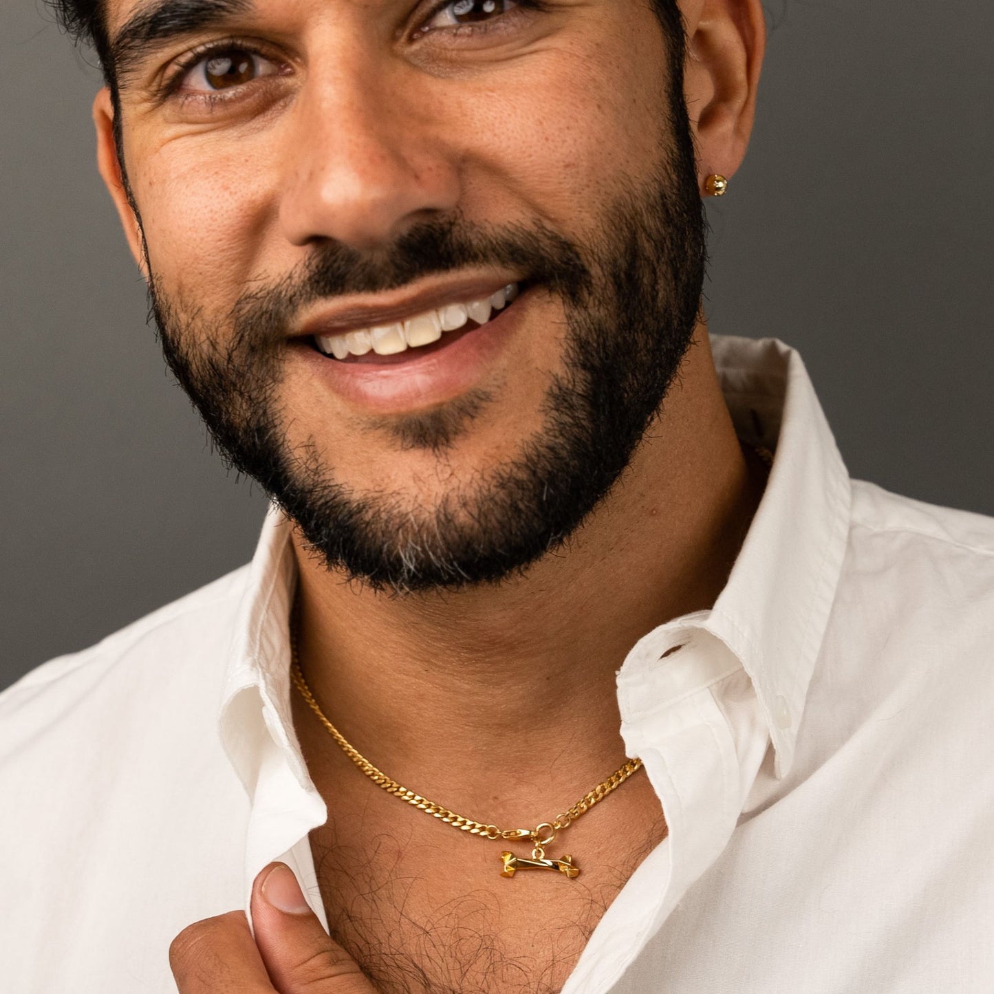male model wearing the mars dog bone necklace in 18k gold vermeil and the fran ball stud earring in 18k gold vermeil