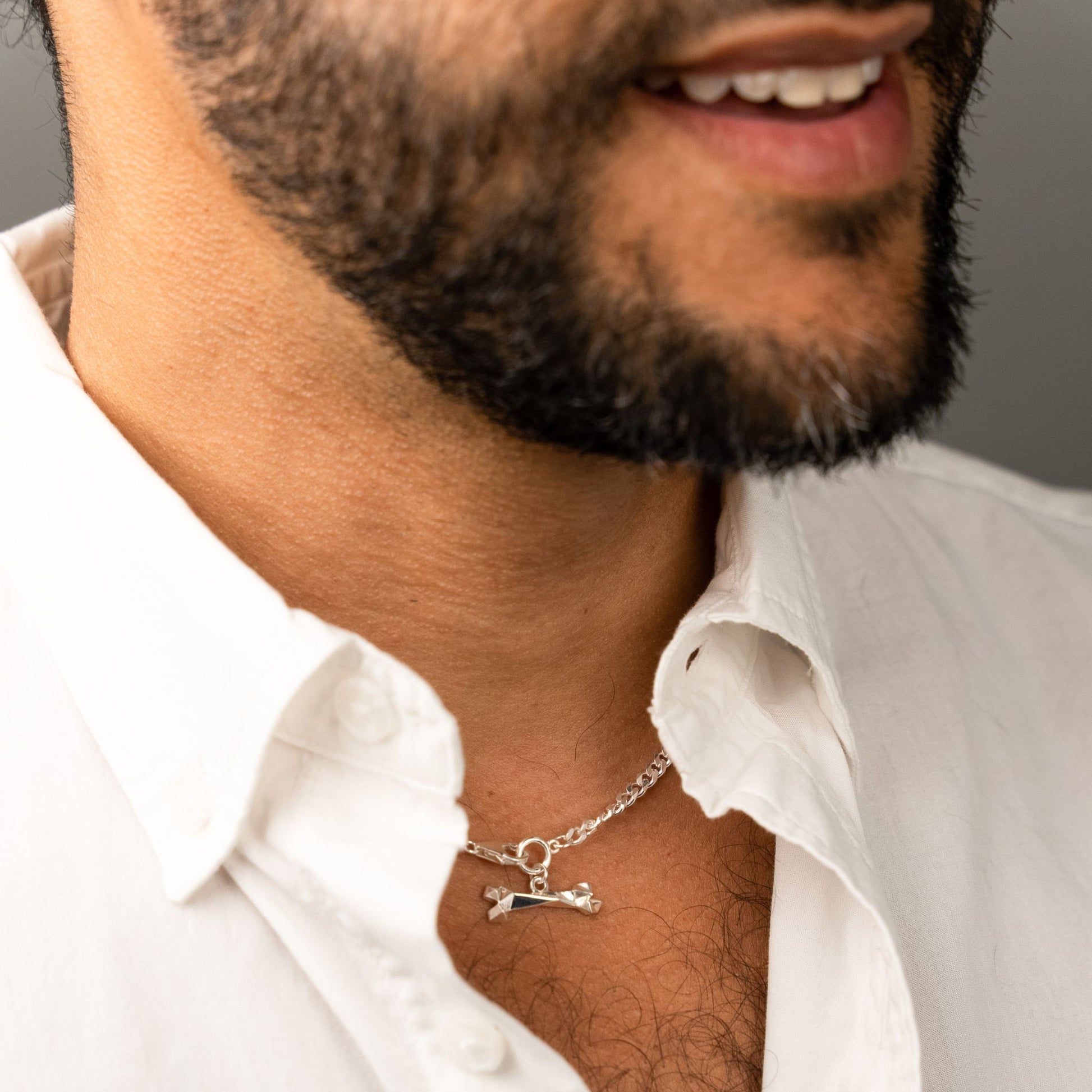 male model wearing the mars dog bone necklace in sterling silver