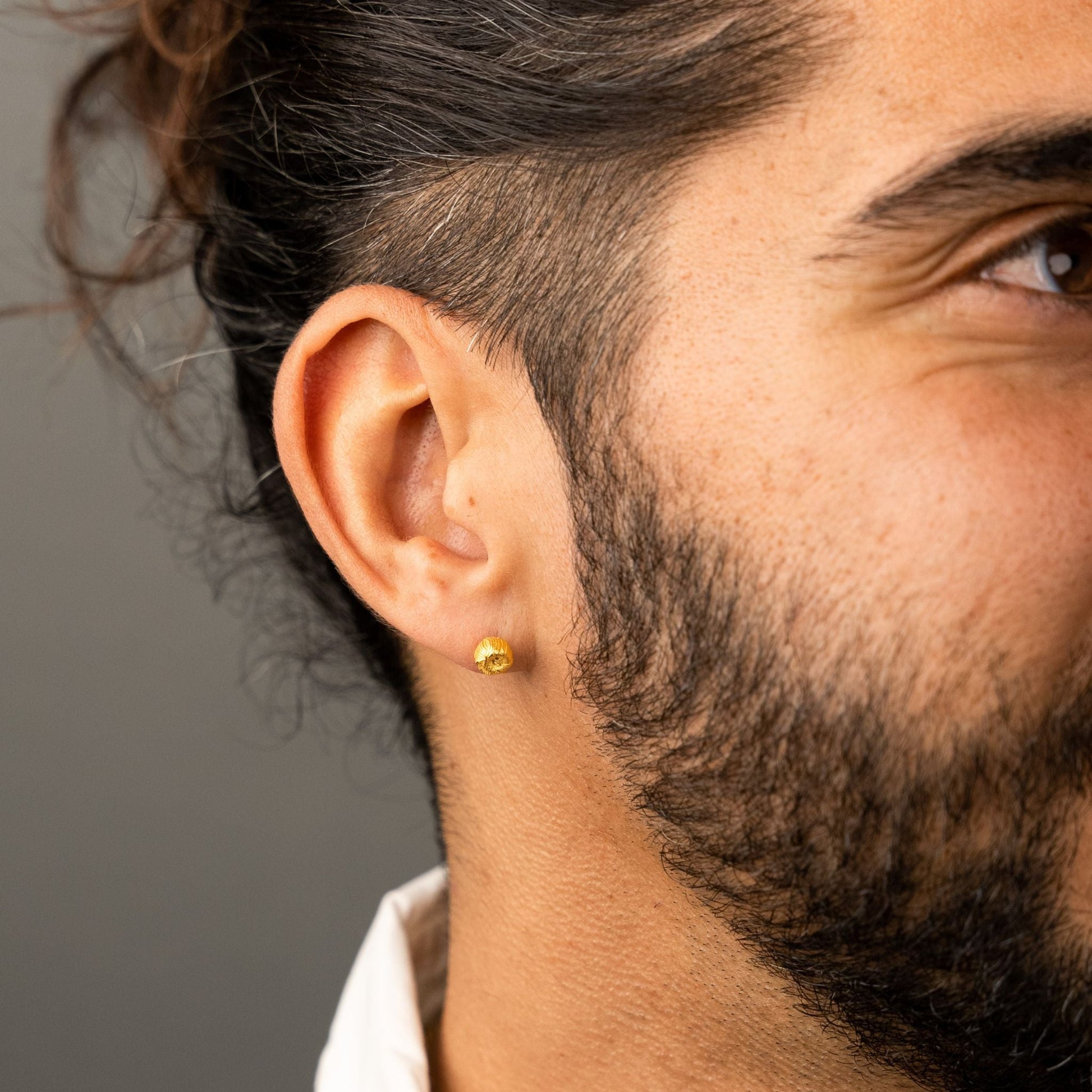 male model wearing the ren yarn stud earring in 18k gold vermeil