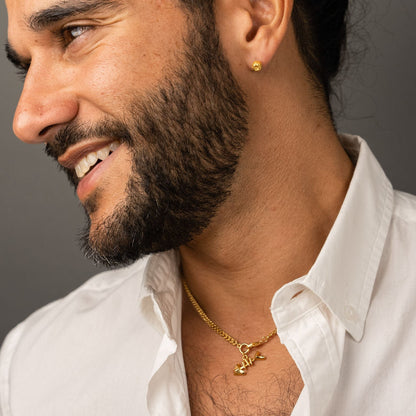 male model wearing the ren yarn stud earring in 18k gold vermeil and the mars fish bone necklace in 18k gold vermeil